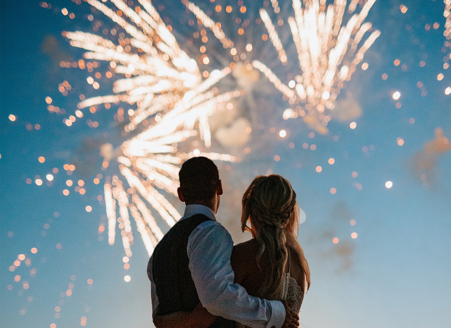 couple watching the firework show in his wedding night